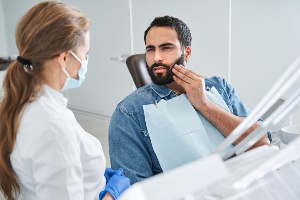 dental patient holding mouth in pain