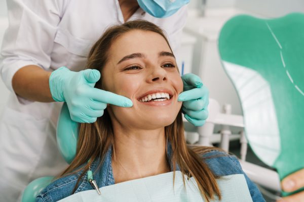 patient looking at her smile in the mirror