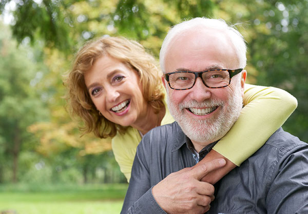 elderly couple smiling at a park